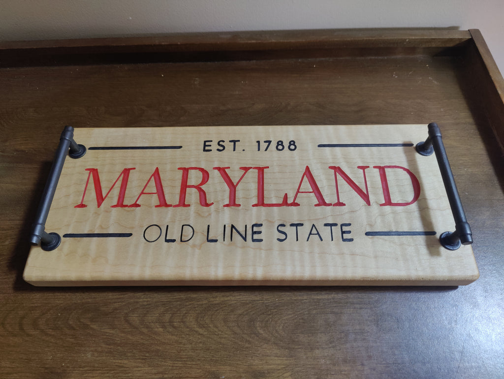 A rectangular wooden sign with a light natural wood background, featuring 'MARYLAND' in large red letters and 'EST. 1788' and 'OLD LINE STATE' in black.